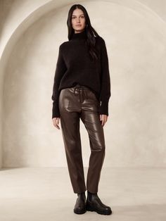 We selected a luxurious quality of vegan leather for this jogger-style pant, cut with a mid-rise and a slim, tapered leg.  Mid rise.  Slim, tapered leg.  Ankle length.  Elastic waistband with drawstring.  Front pockets.  Unlined.  Mid rise (9").  Slim through the hip and thigh, tapered leg.  Ankle length.  Inseams: Petite/Short 25", Regular 27", Tall 30" Model: Size S, 5'10" (178cm). Brown Leather Pants Outfit, Brown Leather Pants, Leather Pants Outfit, Leather Joggers, Style Pant, Espresso Brown, Petite Shorts, Banana Republic Pants, Fashion Joggers