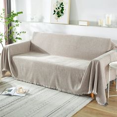 a living room with a couch covered in a blanket