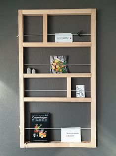 a book shelf with several books on it and a sign hanging from the wall next to it