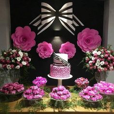 a table topped with pink flowers and a cake