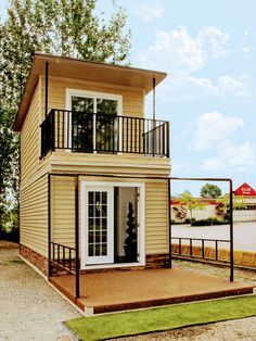 a small house with a porch and balcony