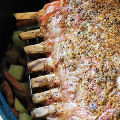 the meat is covered with seasoning and sits next to sweet potatoes in a blue dish