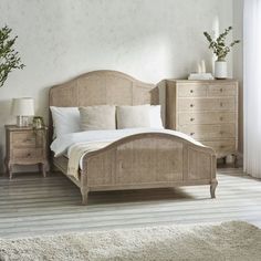 a bedroom with a bed, dresser and two nightstands