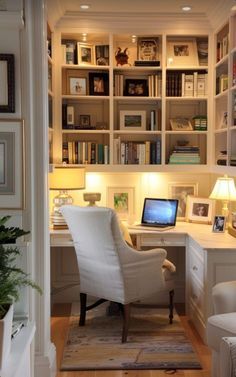 a home office with built in bookshelves and desk