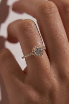 a woman's hand with a diamond ring on it