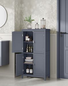 a grey cabinet with bottles and glasses on it