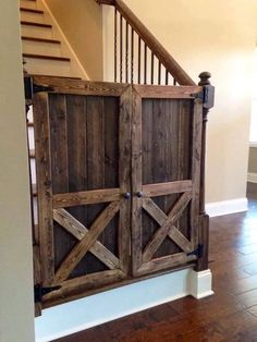 an open wooden door on the side of a stair case next to a banister