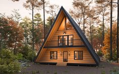 a - frame cabin in the woods surrounded by trees