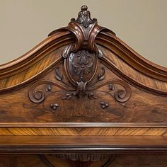 an ornate wooden bed frame with carvings on it