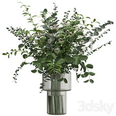 a vase filled with lots of greenery on top of a table