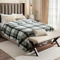 a bedroom with a large bed and wooden headboard