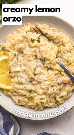 a bowl of creamy lemon orzo made in one pot and served with a slice of lemon