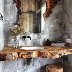 a bathroom with a wooden counter top and mirror above the sink in front of it