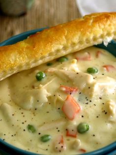 a blue bowl filled with chicken pot pie soup