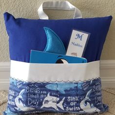 a blue and white bag with some books in it