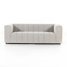 a gray couch sitting on top of a white floor