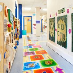 the hallway is decorated with brightly colored carpets and pictures on the wall, along with toys