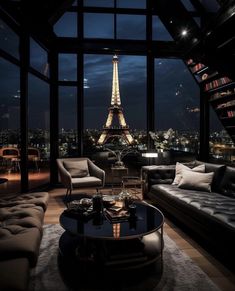 a living room filled with furniture and a view of the eiffel tower at night