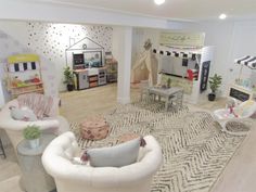 a living room filled with lots of furniture and decor on top of a hard wood floor