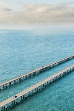 an aerial view of two bridges over the ocean