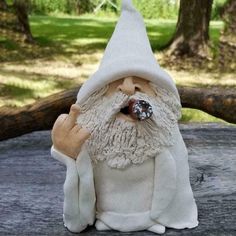 a gnome statue sitting on top of a wooden table