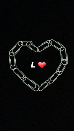 a heart shaped chain with the word i love you written on it in white ink