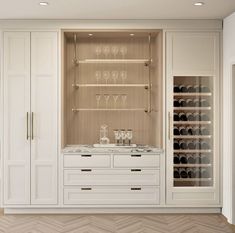 a wine cellar with white cabinets and marble counter tops