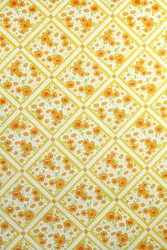 an orange and yellow flower pattern on white fabric