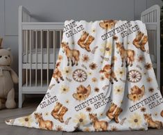 a baby crib with a blanket that has bears on it and the words cleveland