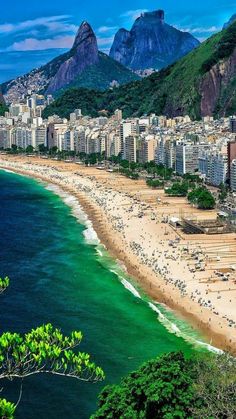 an aerial view of the beach in rio, with mountains in the backgroud