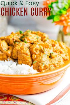 an orange bowl filled with chicken curry and white rice on top of a colorful place mat