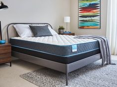 a bed with a blue mattress on top of it