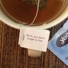 a cup of tea with a note attached to it