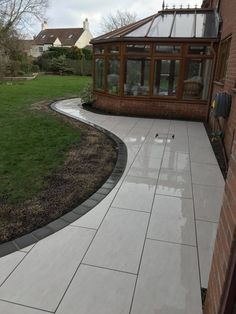 a house with a large lawn and patio area