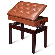 a brown leather ottoman sitting on top of a wooden table with an open drawer underneath it