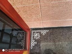 a close up of a window on the side of a building with an ornamental design