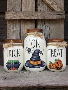 three painted mason jars with witches and pumpkins on them, one for trick or treat