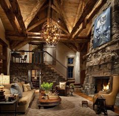 a living room filled with lots of furniture and a fire place in the middle of it