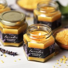 several jars filled with candles sitting on top of a table