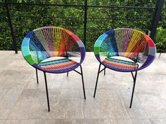 two colorful chairs sitting next to each other