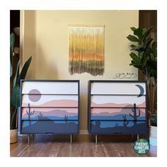 two painted dressers sitting on top of a hard wood floor next to a potted plant