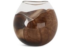 a glass vase with wood in it on a white background