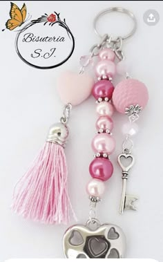 the key chain is decorated with hearts, pearls and other accessories for someone's special occasion