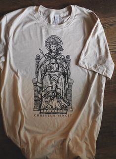 Christ the King Graphic Catholic Unisex Tee The t-shirt feels soft and lightweight, with the right amount of stretch. It's comfortable and flattering for all. Please check the size chart in the images for fit specifications per size. * 100% combed and ring-spun cotton (Heather colors contain polyester) * Fabric weight: 4.2 oz (142 g/m2) * Pre-shrunk fabric * Side-seamed construction * Shoulder-to-shoulder taping ©2021-2023 Mater Christi Apparel PLEASE NOTE: - We use a third party printer for our t-shirts and art prints. If you order more than one product from our shop, shipments may be sent separately. - We do not accept returns, exchanges, or cancellations (12 hours after purchase) for products ordered in the wrong color or size. Please make sure to see the size chart in the photos above. Graphic Tee Christian, Vintage Christian Shirts, Catholic T Shirts, Catholic Clothing, Catholic Tshirt, Jesus T Shirts Graphic Tees, Catholic Tshirts, King Tshirt, Christ The King