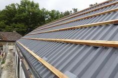 a metal roof with wood shingles on it