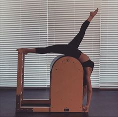 a woman doing yoga on an exercise machine