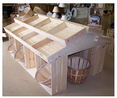 a house made out of wooden planks and buckets on the floor in a shop