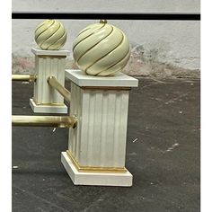 two white and gold vases sitting on top of each other