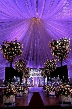 an aisle decorated with flowers and lights