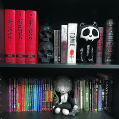 a book shelf filled with books and stuffed animals on top of eachother's shelves